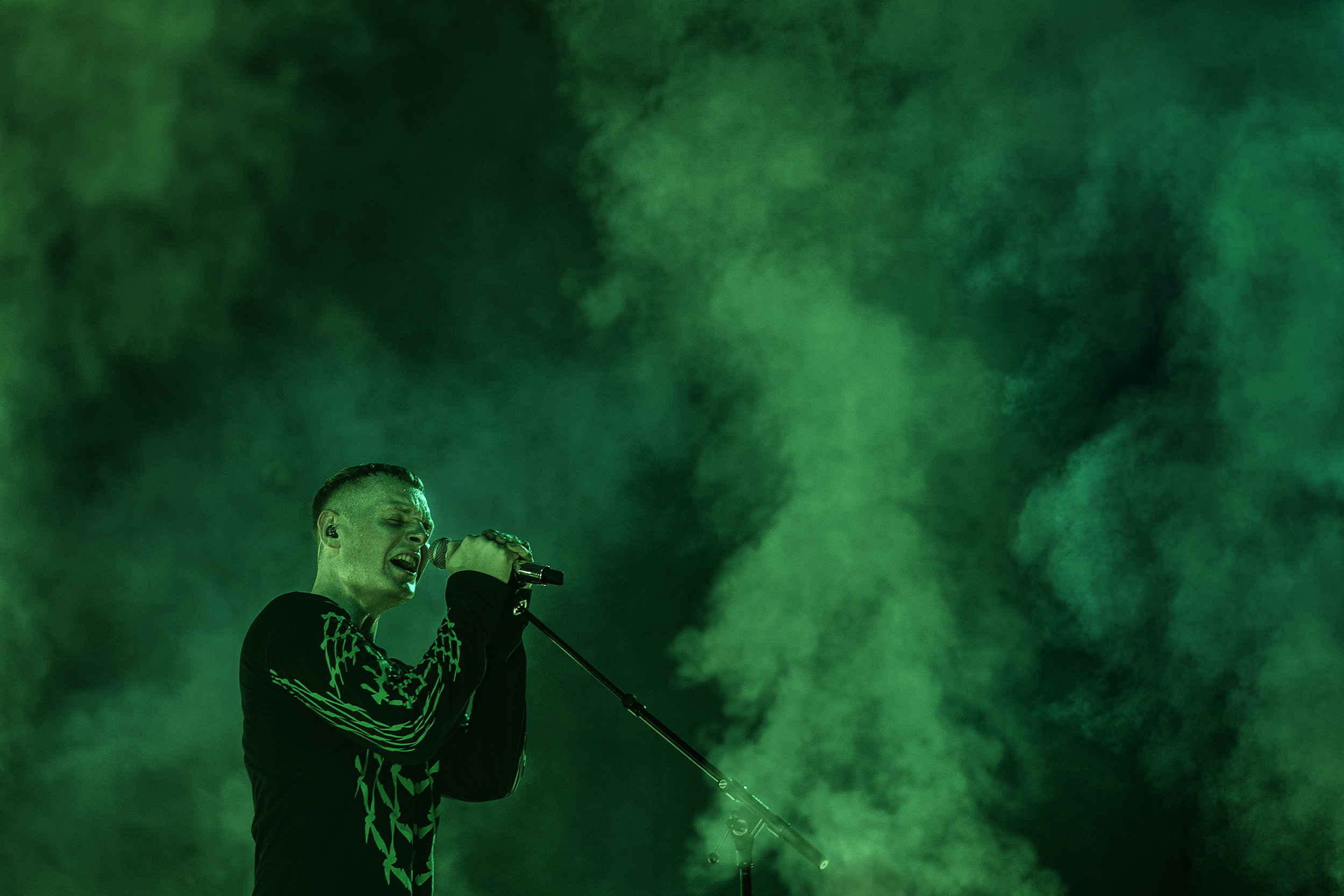 singer-on-stage-surrounded-by-green-smoke.jpeg