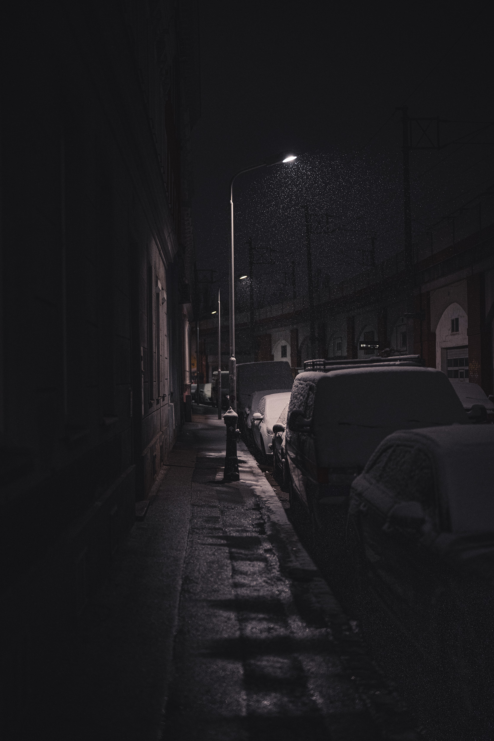 a-light-snow-falling-on-cars-at-night.jpg