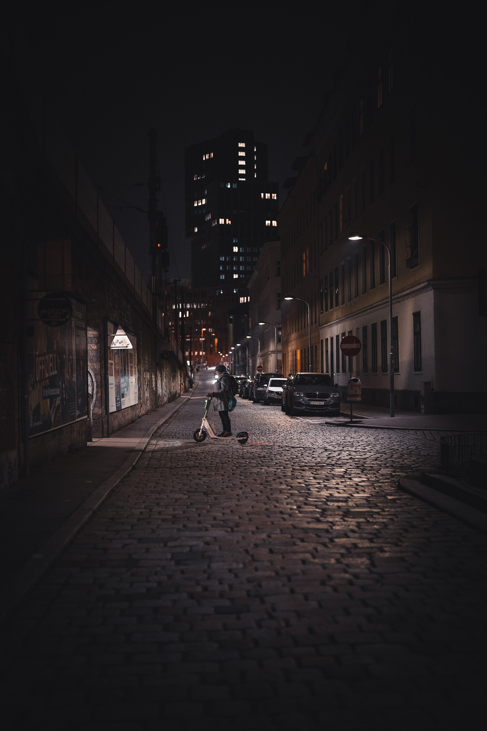 person-on-a-scooter-at-night-in-vienna.jpg