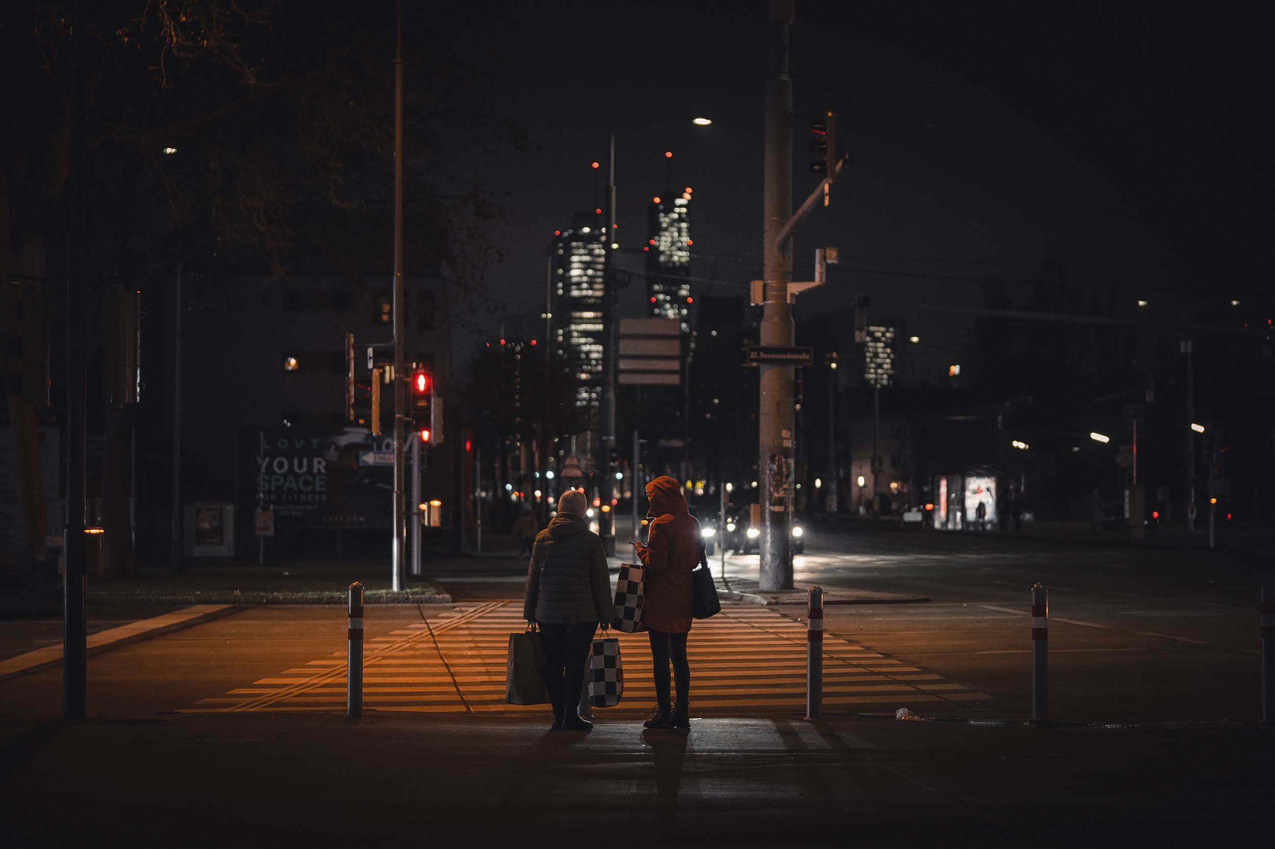 2-ladies-about-to-cross-the-street-at-night-in-vienna.jpg
