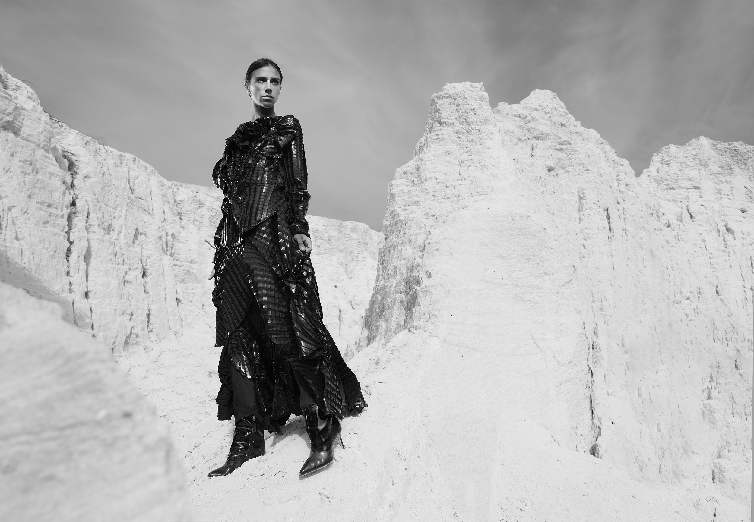 model-in-a-black-dress-standing-next-to-a-white-cliff.jpg