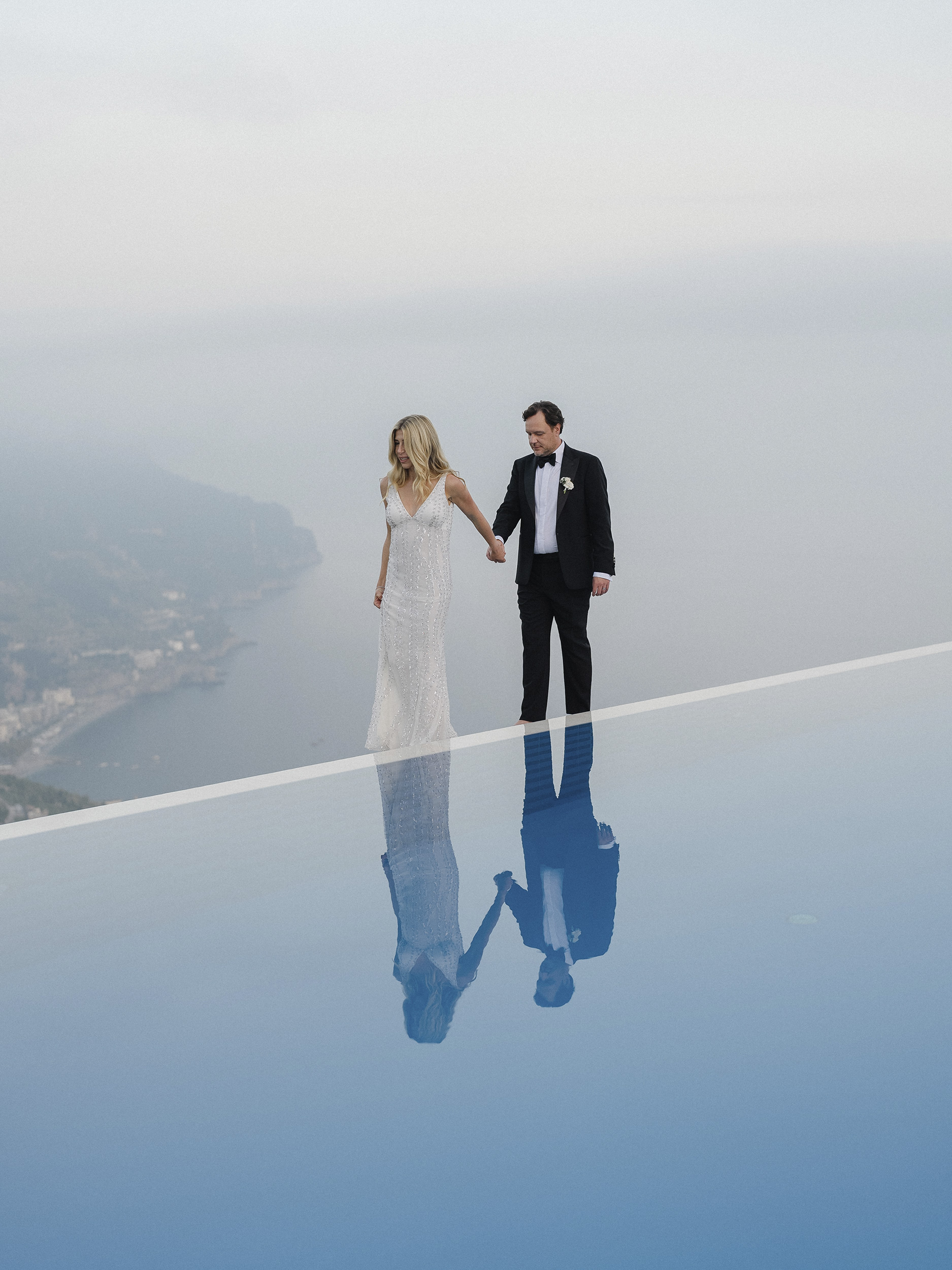 bride-and-groom-reflected-in-a-swimming-pool.jpg