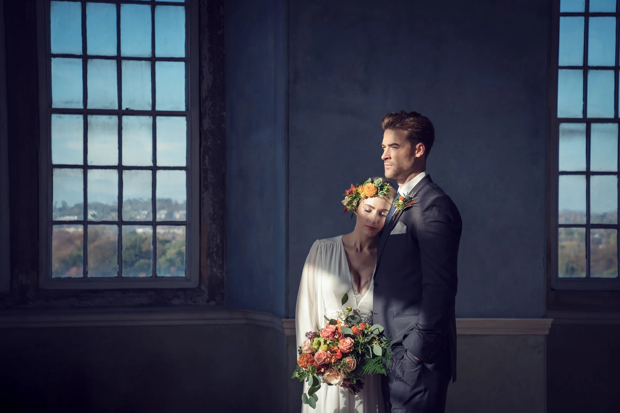 kate-hopewell-smith-sony-alpha-9-bride-and-groom-pose-formally-in-front-of-a-window-after-the-ceremony.webp