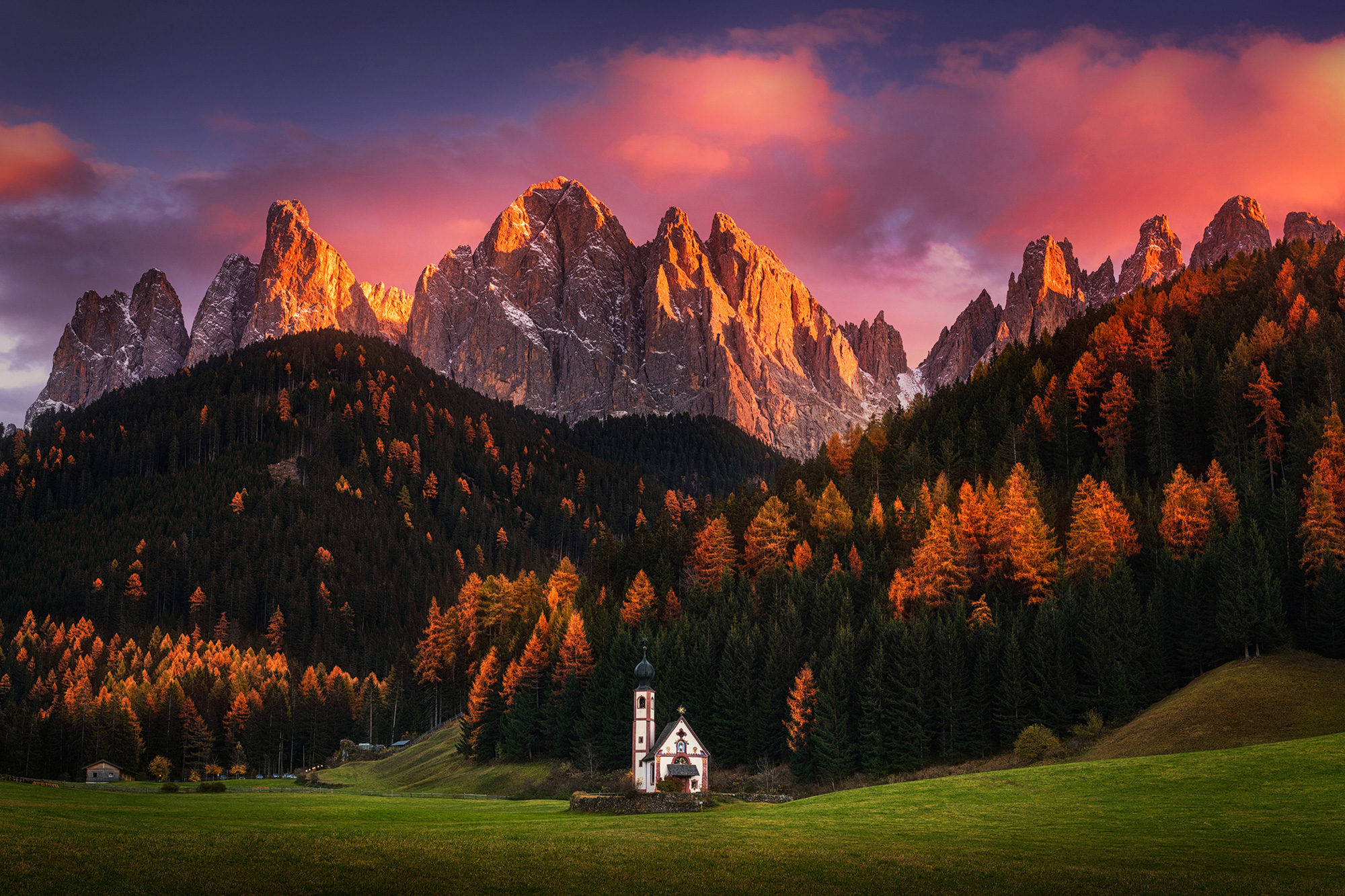 albert-dros-sony-alpha-7RII-a-small-church-sits-in-the-shadow-of-a-mountain-with-the-peaks-illuminated-in-golden-orange.jpeg